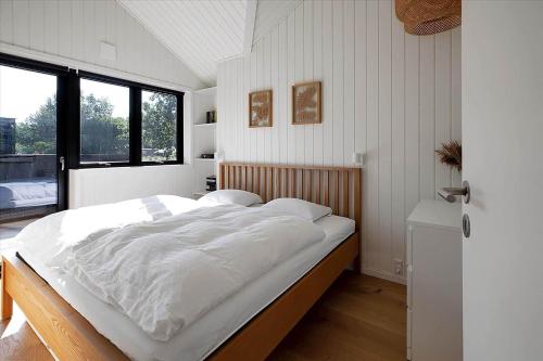 a large white bed in a room with a window at 13397-Vig-Lyngkrogen-21 in Vig