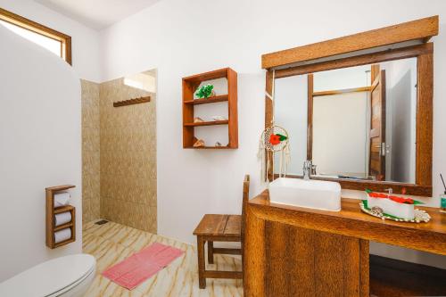 a bathroom with a sink and a mirror at Haber Hotel & SPA in Matemwe