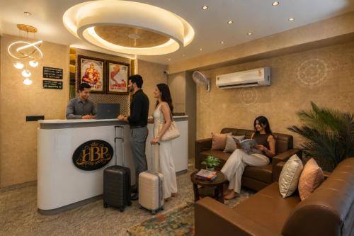 a group of people standing around a counter in a room at Perfectstayz Premium Vrindavan - Near Prem Mandir in Vrindāvan