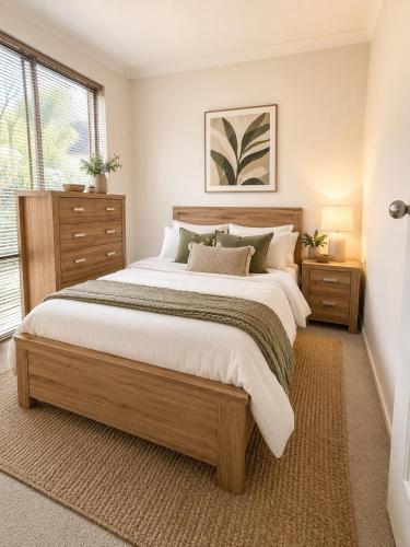 a bedroom with a large bed and a window at Coastal Haven Retreat 3BR Escape in Kinross in Kinross