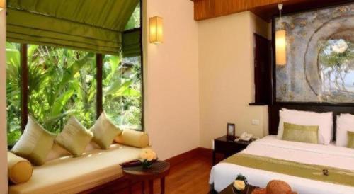a bedroom with two beds and a large window at Baan Talay Dao Resort in Hua Hin