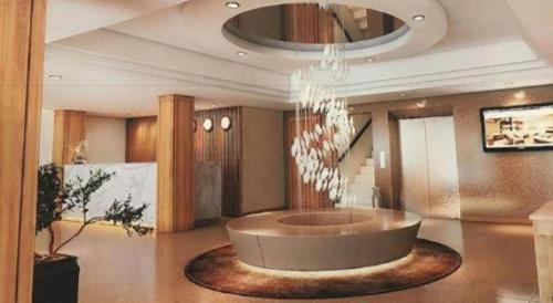 a large lobby with a circular table in the middle at Saigon Star Hotel in Ho Chi Minh City
