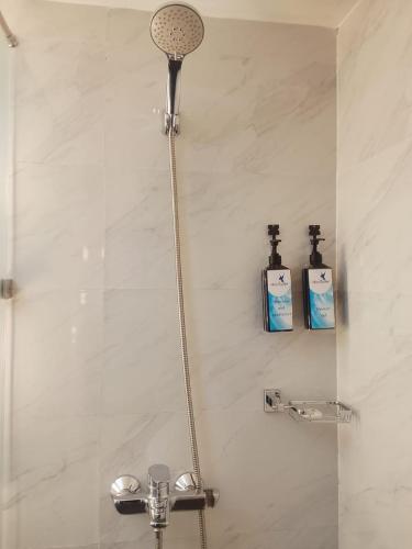 a shower with two bottles ofodorizers in a bathroom at Hummingbird St.Clare Villas in Dimbula