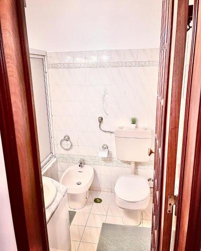 a bathroom with a toilet and a sink at New in Loures in Lisbon