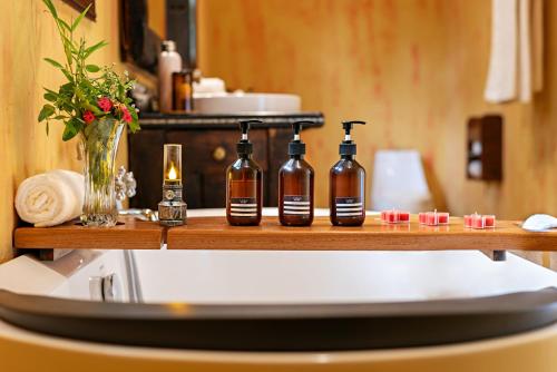 a shelf with four bottles on top of a counter at Buffalo Safari Lodge in Katunguru