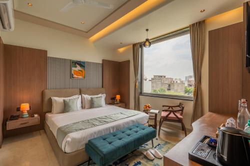 a bedroom with a large bed and a large window at Perfectstayz Premium Vrindavan - Near Prem Mandir in Vrindāvan