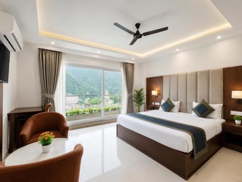 a hotel room with a bed and a window at Hotel Weekend Heights in Rishīkesh