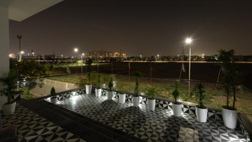 a row of potted plants on a balcony at night at The Afternoon Stays in Mohali