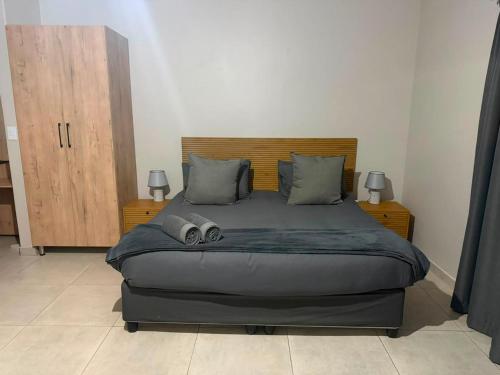 a bedroom with a large bed with two pillows at Green Haven 2 in Tzaneen