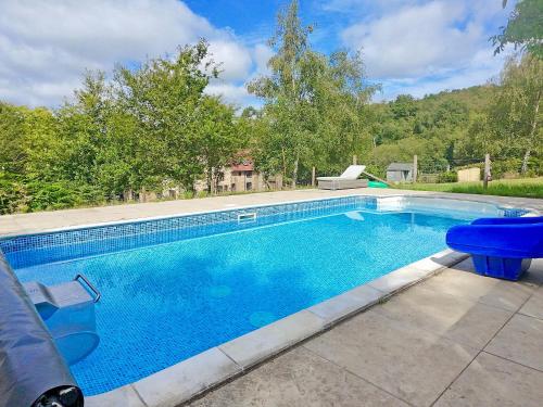 a large swimming pool in a yard with at Swallows Bottom in Henley