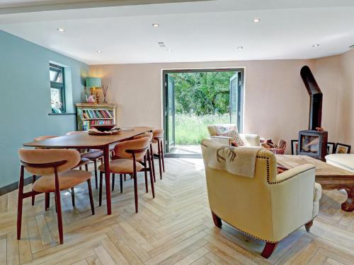 a living room with a dining room table and chairs at Swallows Bottom in Henley