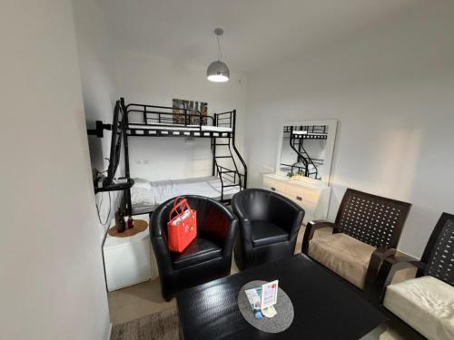 a living room with a couch and a bunk bed at Zimmer Monte in Dāliyat el Karmil