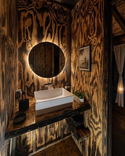 a bathroom with a sink and a mirror at Sunset Calm Retreat Bungalow in Haleiwa