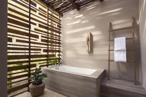 a bathroom with a bath tub and a plant at Alila Mayakoba by Hyatt in Playa del Carmen