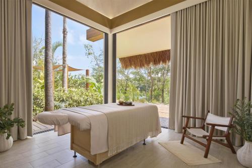 a bedroom with a bed and a large window at Alila Mayakoba by Hyatt in Playa del Carmen