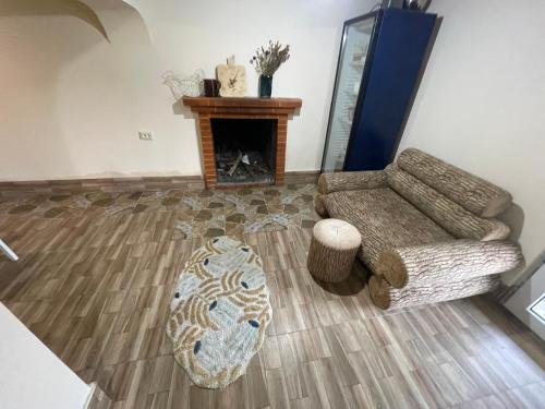 a living room with a couch and a fireplace at Mukha in Tbilisi City