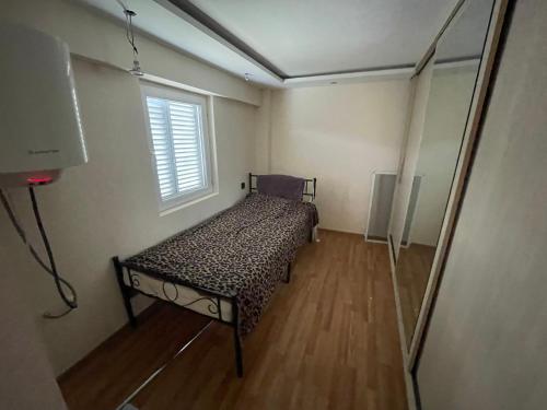 a bedroom with a bed in a room with a window at Mukha in Tbilisi City