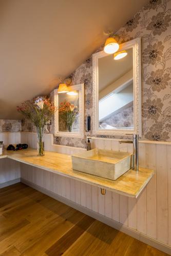 a bathroom with a sink and a mirror at Casona Naviega in Navia