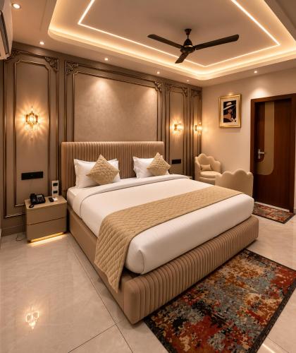 a bedroom with a large bed and a chair at Panipat Prime in Pānīpat