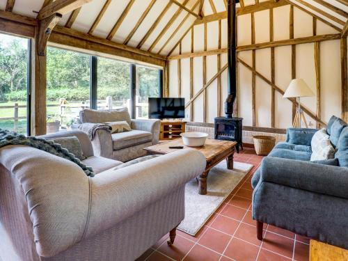 a large living room with couches and a fireplace at Glebe Stables in Steyning