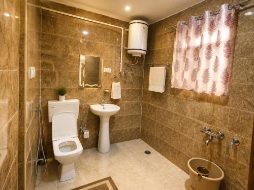 a bathroom with a toilet and a sink and a shower at Gulmarg Gul Sitara Resorts in Gulmarg