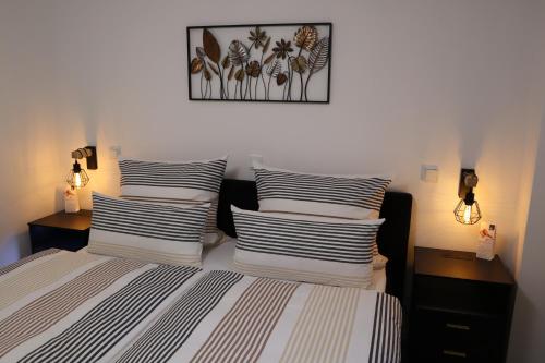 a bedroom with a bed with four pillows on it at Ferienwohnung Frankenruhe in Strullendorf