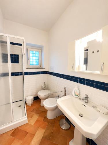 a bathroom with a toilet and a sink and a shower at Punta Fortino Resort in Agropoli