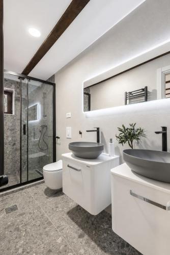 a bathroom with two sinks and a shower at Split Old Town Rooms Matushko in Split