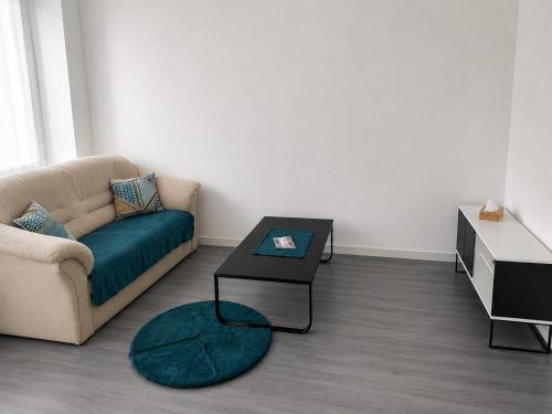 a living room with a couch and a table at Violette 2 in La Souterraine
