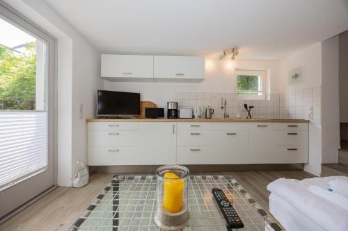 a kitchen with a trash can in the middle of a room at Stabenweg Whg. 1 in Göhren