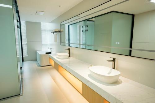 a bathroom with two sinks and a mirror at 玉恒酒店 in Sihui