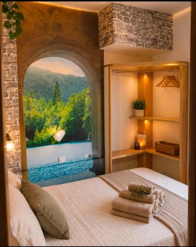 a bedroom with a bed with a large window at Parascheva St Jordi in Tossa de Mar
