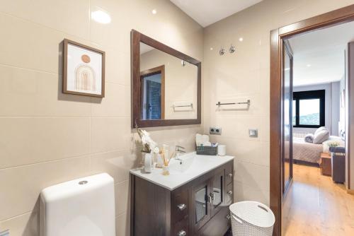 a bathroom with a sink and a mirror at Villa Ana Esperanza - El Espinar in El Espinar