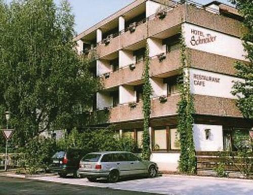 a car parked in front of a building at Hotel Schneider in Bad Säckingen