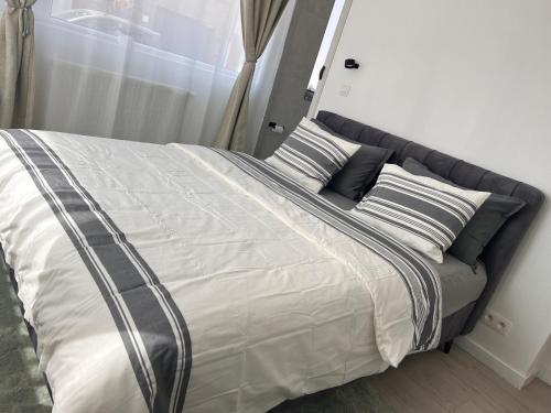 a large bed with two pillows on top of it at Modern private Rooms with attached Bathroom & Free Parking in Bruges