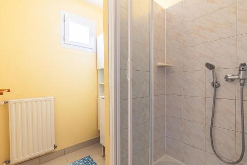 a bathroom with a shower with a glass door at Duplex N°6 - Résidence Balnéaire in Le Port-des-Barques