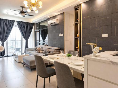 a kitchen and living room with a table and chairs at 2BR Infinity Pool Condo Near Jonker 5Pax in Malacca