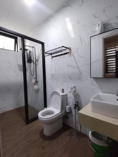 a bathroom with a shower and a toilet and a sink at 2BR Infinity Pool Condo Near Jonker 5Pax in Malacca
