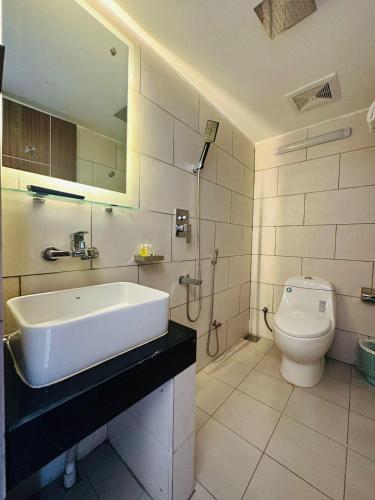 ein Badezimmer mit Waschbecken und Toilette in der Unterkunft White Park Hotel & Suites in Chittagong