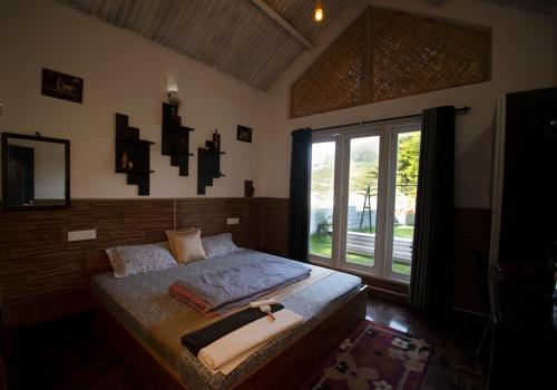 a bedroom with a bed with a cross on it at The Chill Inn ''Families Only'' By Green Leaves in Ooty