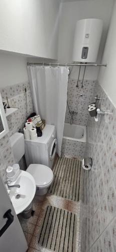 a small bathroom with a toilet and a sink at Apartman-Zara m in Zadar