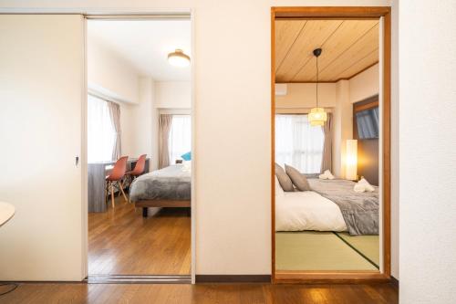 a bedroom with a mirror and a bed in a room at CS Residence Chiba in Chiba