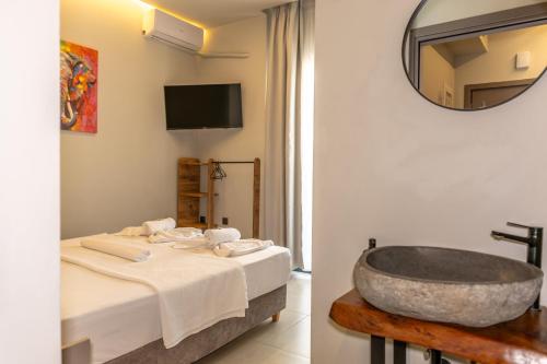 a bathroom with a sink and a bath tub at Baja Suites in Kalamata