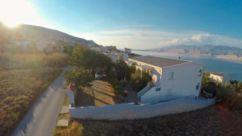 an aerial view of a house next to the water at Apartments Alma in Pag