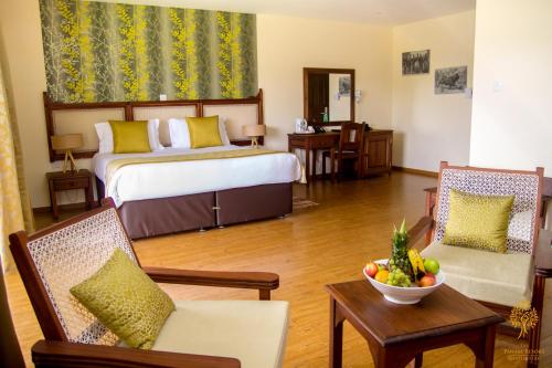 a hotel room with a bed and a bowl of fruit at Panari Resort, BW Signature Collection in Nyahururu