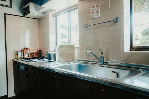 a kitchen with a large sink and a window at Kacho-en / Vacation STAY 1048 in Mitoyo