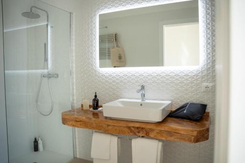 a bathroom with a sink and a mirror at Masseria Filippo de Raho - Agri Bio Relais in Convento