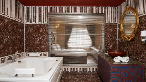 a bathroom with a tub and a sink and a mirror at Elite World Nest Van in Van