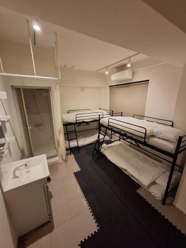 a room with three bunk beds and a sink at Nagoya - Hotel - Vacation STAY 01596v in Nagoya