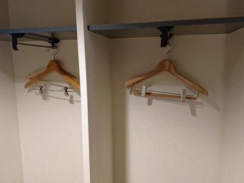 two hangers on a wall in a room at Hotel Oaks Early-Bird Osaka Morinomiya/ Vacation STAY 28708 in Osaka